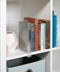 Acrylic Closet Shelf Dividers 8 Pack Clear Organizer for Purses and Sweaters Keeps Your Closet Neat and Accessible Space Saving Shelf Separators Adjustable up to 2.5 Inches Thick in use, holding books on a white shelf.