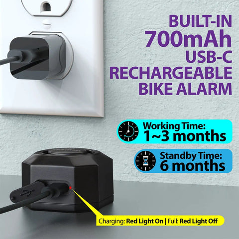 USB-C Rechargeable Bike Alarm With Remote charging with red light indicator visible next to power outlet.