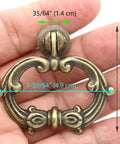 Hand holding 6 Sets Distressed Antique Brass Vintage Cabinet Pulls with Drop Ring Handles for Dresser Drawers and Cupboards 1.9 in by 1.8 in Zinc Alloy