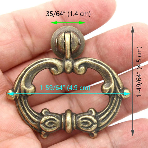 Hand holding 6 Sets Distressed Antique Brass Vintage Cabinet Pulls with Drop Ring Handles for Dresser Drawers and Cupboards 1.9 in by 1.8 in Zinc Alloy