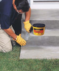 Person using Quick Set Cement And Mortar Mix In A Ten Pound Pail to repair concrete steps in yard.