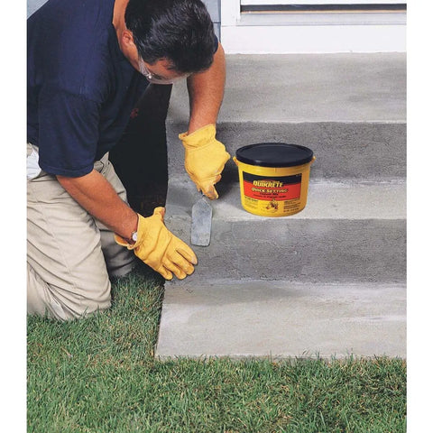 Person using Quick Set Cement And Mortar Mix In A Ten Pound Pail to repair concrete steps in yard.