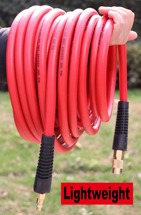 Hand holding red Heavy Duty Hybrid Air Hose 1 Quarter Inch By 100 Feet, 300 PSI, Lightweight And Kink Resistant with couplers.