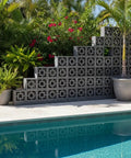 Breeze Brick Molds For Concrete, Double Square Design used in garden decor, forming a decorative wall by the poolside.
