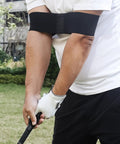 Golfer using Golf Swing Trainer Aid With Grip Trainer Attachment And Arm Band For Swing Correction in backyard practice.