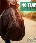 Heavy Duty Contractor Trash Bags 55 Gallon 3 Mil Extra Large 50 Bags With Ties Mega Value held by gloved hand