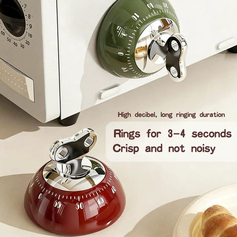 Red and green 60 Minute Magnetic Timer For Fridge Magnet And Kitchen Use on microwave, highlighting noiseless ring feature.