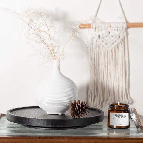 Premium Wood Lazy Susan Turntable Functions As Slick Kitchen Game Changer With Smooth Swivel Glide Waterproof 11 Inch Black Round Serving Tray on display with vase and candle.