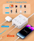 Plug Away With This Slick Flat Surge Protector Power Strip Featuring Eight Roomy Ac Outlets And Four Fast Usb Ports To Charge All Your Gear Smoothly Without Cluttering Your Desk Or Emptying Your Wallet, showing USB connections to a phone.