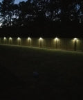 Solar Fence Post Lights Wall Mount Deck Lighting Black 4 Pack illuminating garden pathway at night with ease and durability.