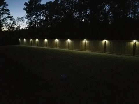 Solar Fence Post Lights Wall Mount Deck Lighting Black 4 Pack illuminating garden pathway at night with ease and durability.