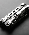 Sixteen-In-One 420 Stainless Steel Multitool Pliers with full locking safety and belt clip on dark surface, compact and sturdy design.