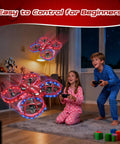 Kids playing with Mini Drone For Kids Beginners Toss To Go RC Quadcopter With LED Lights indoors at night.