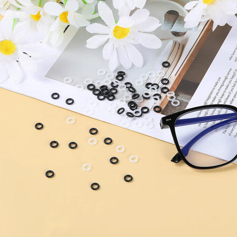 Glasses Tightening Kit With 100 Silicone Anti Slip Rings 4mm To Stop Slipping displayed next to eyeglasses on table