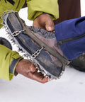 Grippy Ice Cleats For Boots And Shoes With Stainless Steel Micro Spikes, Snow Traction Grips being fitted on a hiking boot