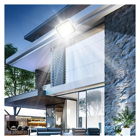JUDYSSY Solar Outdoor Courtyard Lights 5-in-1 Led Beads High-Power Floodlights illuminate a modern house exterior at night.