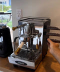 Keep Your Grind Fresh With This Premium Airtight Coffee Bean Storage Tube Set Featuring Four Smart Glass Jars And Clean Counter Display showing espresso machine and glass jar set.