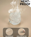 Glass of steaming water on Beige PU Leather Desk Pad Protector And Mouse Pad Large 31.5 By 15.7 Inch Non Slip Waterproof Desk Mat.