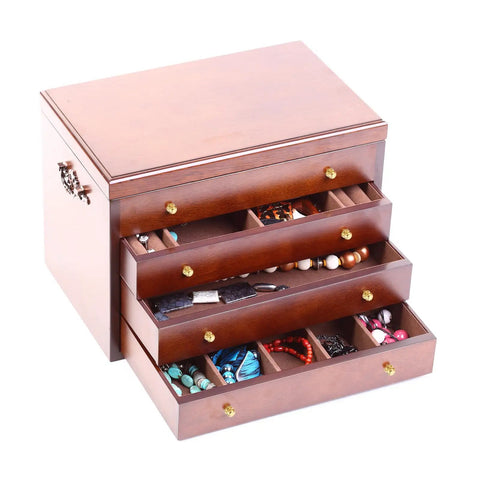 Wooden jewelry box with four open drawers displaying assorted jewelry and accessories, featuring brass handles and decorative knobs.
