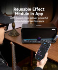 Musician with guitar using 40W Touchscreen Guitar Amp with Built In Audio Separator Looper Drummer Mode 6 Hour Battery on table