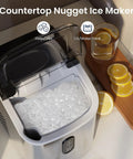 Crunchy Nugget Ice Maker For Countertop With Auto Cleaning 35 Lbs Per Day Portable Sonic Ice Machine filled with ice next to lemons.