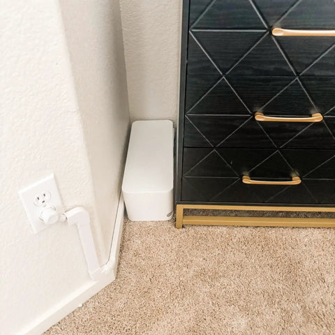 White Two Pack Cable Management Box Set To Hide Power Strips On Desk Or Floor, Cord Organizer next to a black cabinet