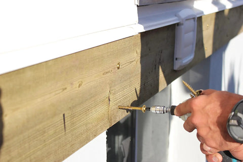Person using Beefy Structural Screws For Wood To Wood Three Eighths Inch By Eight Inch Lag Style Fasteners on wooden deck