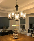 Five Light Black Glass Chandelier With Rustic Metal Pendant Lighting over dining table in farmhouse kitchen setting