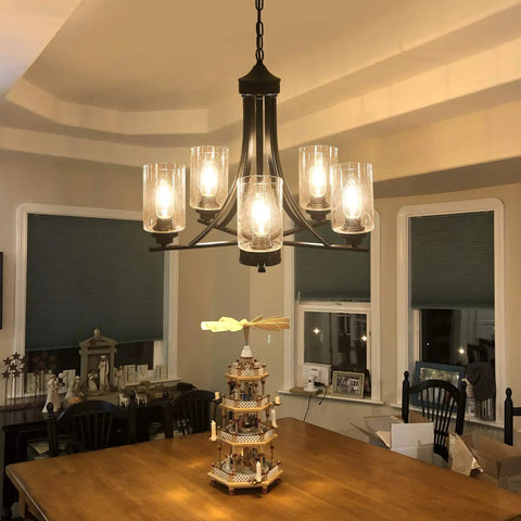 Five Light Black Glass Chandelier With Rustic Metal Pendant Lighting over dining table in farmhouse kitchen setting