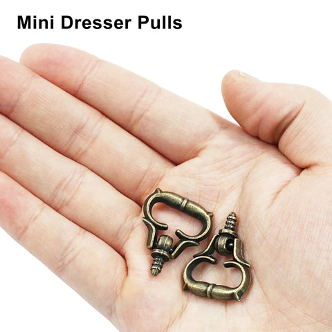 Hand holding antique bronze mini dresser pulls from 20 Pack Mini Bronze Cabinet Handles Set With Self Tapping Screws Zinc Alloy.