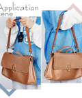 Person holding handbag with 2 Pack 22 Inch Brown Leather Replacement Straps for Purses and Handbags With Antique Bronze Swivel Lobster Buckles.