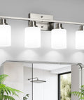 Legit Top Tier Four Light Vanity Mirror Fixture Featuring Brushed Nickel Wall Sconces With Milky White Frosted Glass Panels for bathroom and bedroom use.