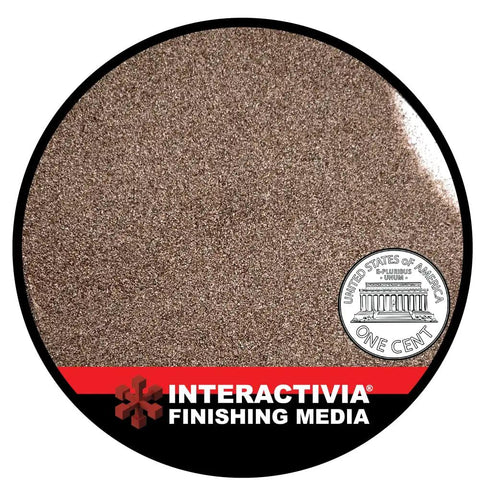 Close-up of 120 Grit Aluminum Oxide Sand Blasting Media For Cabinets And Blasting Guns next to a penny for size comparison.