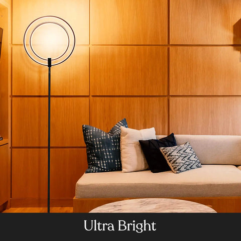 Torchiere-Style No-Fuss Dimmable LED Floor Lamp For Living Rooms And Offices next to a sofa in modern decor setting