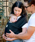 Parents using D Lite Baby Wrap Carrier Ring Sling For Newborn To Toddler With Easy Adjust Ergonomic Comfort And Breathable Fabric outdoors