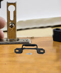 100 Piece Invisible Connector Screws Zero Drama Hidden Furniture Fasteners for cabinet mounting, showing black steel fasteners in use.