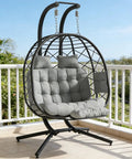 Cozy Double Hanging Egg Chair For Two With Adjustable Footrest And Stand, Indoor Outdoor Wicker Swing With Cushions, Foldable Two Seater, 660Lb Capacity, Perfect For Patio Garden Or Bedroom, Grey on a balcony