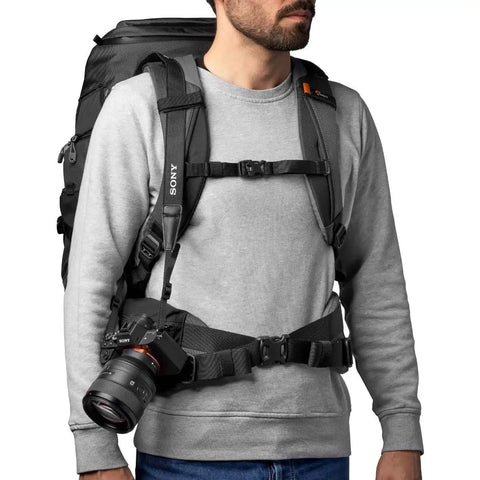Person wearing Pro Trekker BP 550 AW II 40L Camera Backpack for Pro Gear with cushioned shoulders and padded waist belt