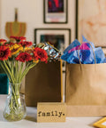 Brown Paper Bags With Handles 8x4.25x10.5 Inches Medium Gift Bags Bulk 100 Pack Recycled Kraft Paper Eco Friendly Shopping Bags decorated with colorful tissue paper.