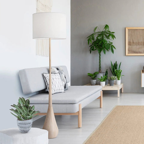 65 Inch Floor Lamp With Wood Toned Finish And White Cotton Shade Japandi Style E26 Base On Off Rotary Switch 5 Ft Cord Cozy Ambient Lighting Vibe For Living Room Or Bedroom set in a modern living room.