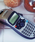 Rock Solid Compact Handheld Label Printer Featuring Bold Fonts And Live Graphical Display for organizing jars and containers.