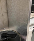 Refrigerator Side Heat Protector Board 40x30cm beside stove, aluminum foil panel shielding cabinet from heat in kitchen setup.