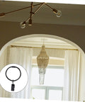 Interior view with white curtains supported by sturdy metal curtain clips with hooks and rings for drapery