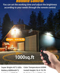 Hand using remote to adjust Solar Flood Light Outdoor 1000LM Dual 6000K on large barn, night view with specifications overlay.