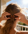 Woman using Magnetic Hair Clips For Women With Strong No Slip Hold Seamless 2 In 1 Design For Thick Or Thin Hair on balcony.