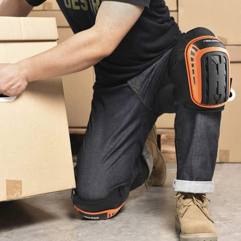 Person wearing Heavy Duty Gel Padding Knee Pads With Strong Double Straps For Work, Indoor And Outdoor Use, Bright Orange, kneeling with box