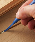 Reusable Glue Spreader Paddles Set Of Three With Four Tip Widths One Eighth To One Half Inch For Precise Glue Application Reaching Tight Corners Handy Grip And Easy To Clean Glue Tool For Grooves Dados And More in use on a wooden groove