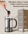 French Press Coffee Maker 34 Ounce Plastic Free Brewing Surface With Thickened Glass And Stainless Steel in use with scoop, dark pewter finish