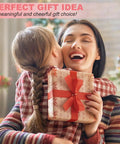 Woman hugging child while holding gift with red ribbon indoors.