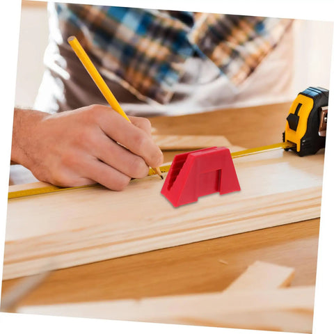Person using red carpenter's square tool with tape measure on wooden board during woodworking project